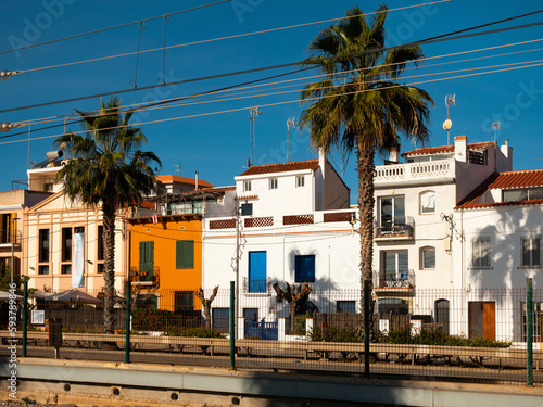 Scenic view of Spanish city of Vilassar de Mar overlooking typical buildings along street on sunny day, Catalonia photo