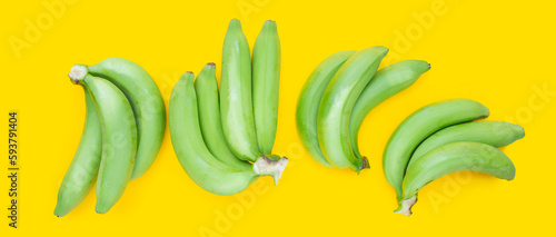 Fototapeta Naklejka Na Ścianę i Meble -  Green banana on yellow background
