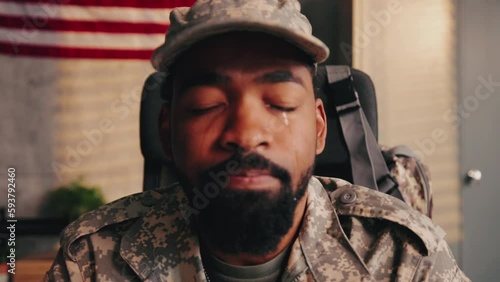 Close up on American soldier crying in office.