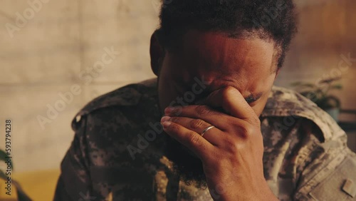 Emotional soldier crying in therapist office.
