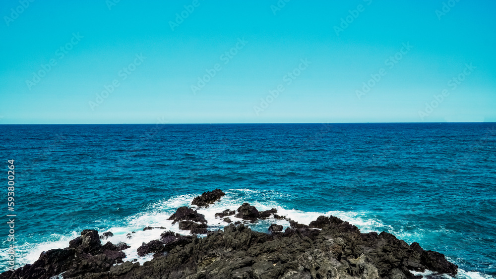 Blue sky and summer sea with rocky wave foam Blue sky and summer sea with rocky wave foam