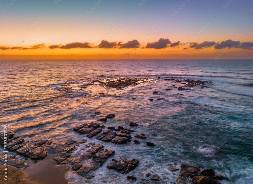 Aerial sunrise seascape with  high tide and rock platform
