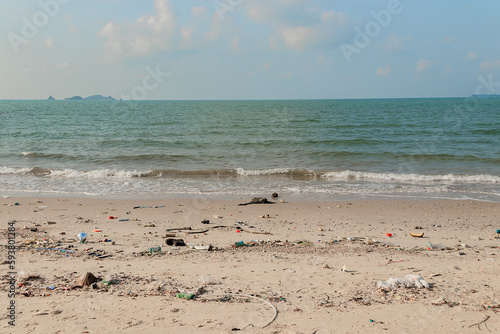 Beach pollution. plastic bottles and other trash on sea beach. © Chalearmrat