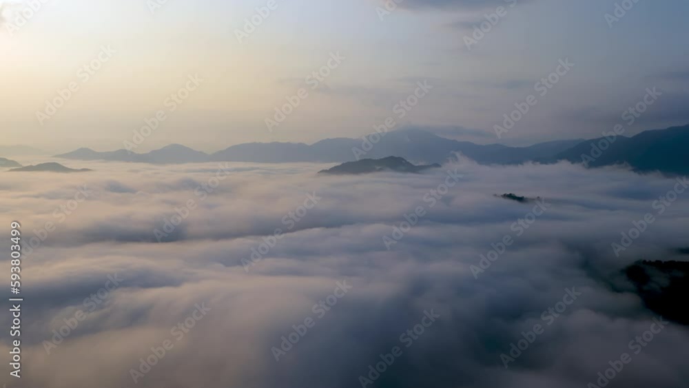 Time Lapse: Morning clouds and fog swirl over mountain peaks at sunrise Time Lapse: Morning clouds and fog swirl over mountain peaks at sunrise