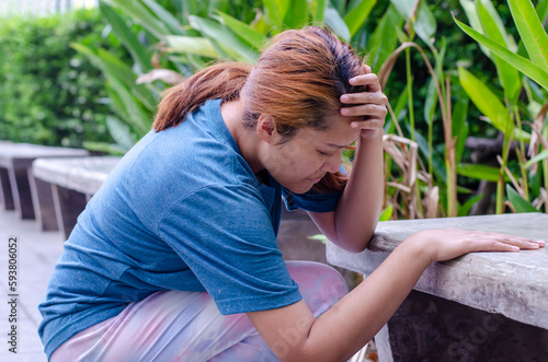 Asian women sitting experiencing dizzy or fainting photo