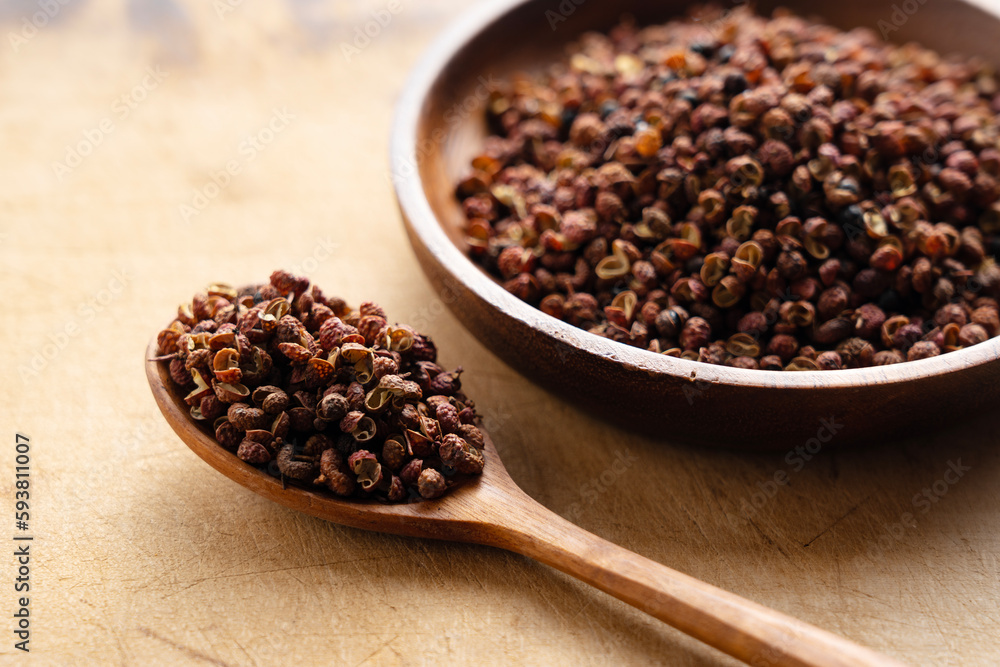 Sichuan pepper and wooden spoon on the table. Sichuan pepper and wooden spoon on the table.