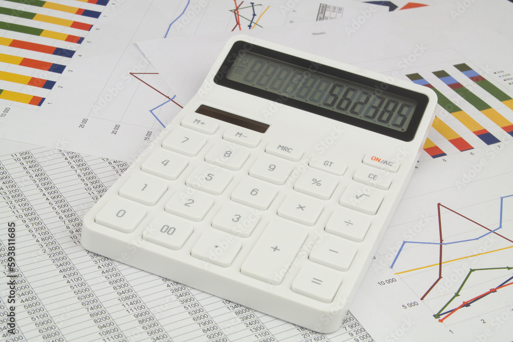 Calculator with numbers on screen on papers with data. Calculator with numbers on screen on papers with data.