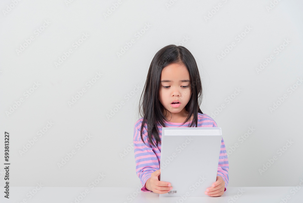 education and school concept - little student girl reading book education and school concept - little student girl reading book
