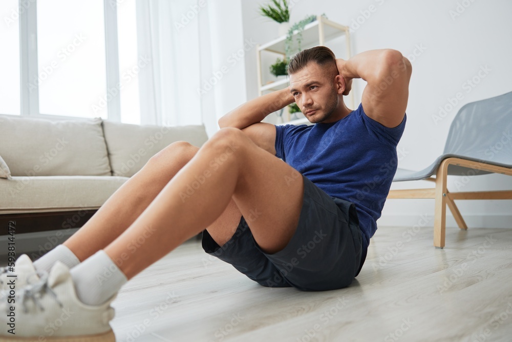 Fototapeta premium Man sportsman training at home, push-up exercises for arm, leg and back muscles, strong body and correct posture, the concept of health and beauty