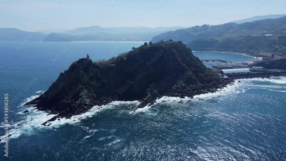 Deep blue water of Biscay Bay in sunshine, Getaria lighthouse on coast Deep blue water of Biscay Bay in sunshine, Getaria lighthouse on coast