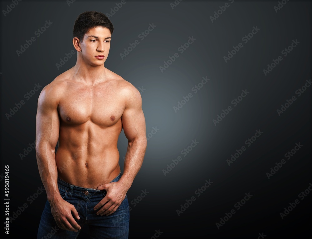 Fototapeta premium Hot muscular man model on dark background.