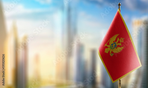 Small flags of the Montenegro on an abstract blurry background