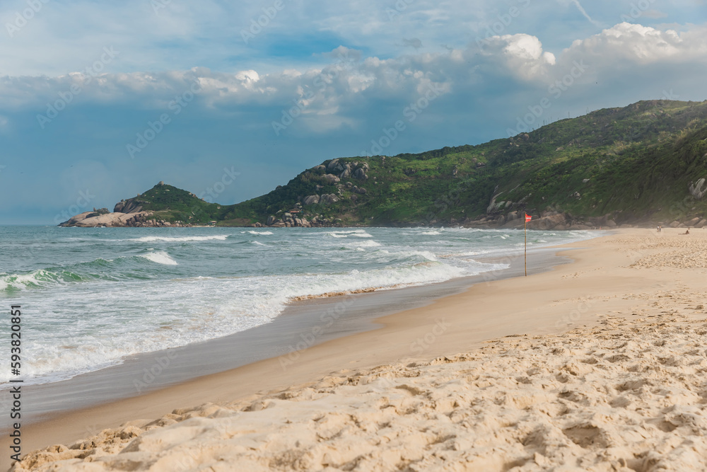 Scenic sandy beach before an oncoming storm. Mole beach in Florianopolis Scenic sandy beach before an oncoming storm. Mole beach in Florianopolis