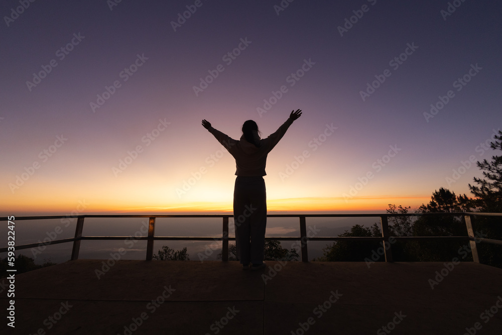 Silhouette of  Woman raising his hands in worship, woman praying for god, Christian Religion concept background.