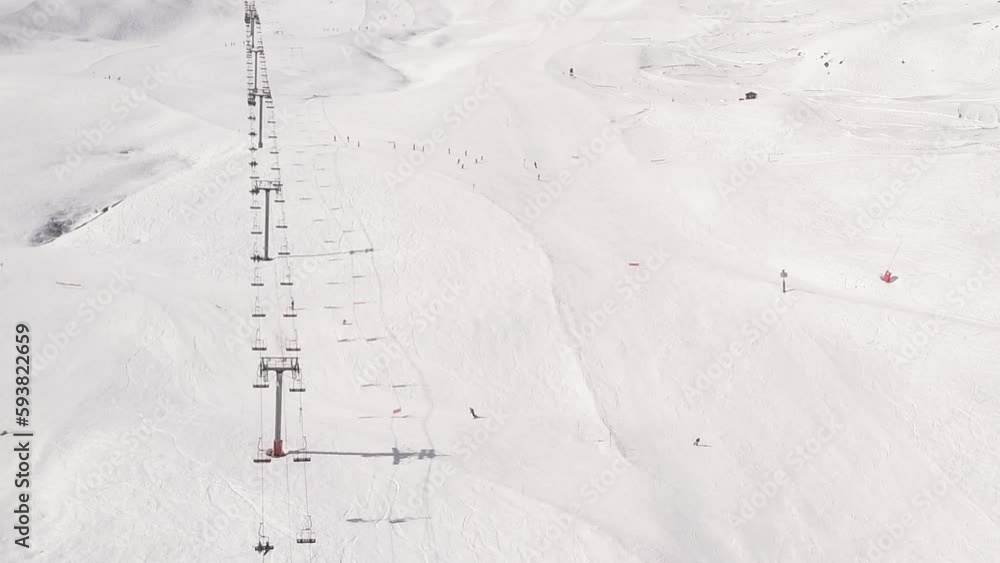 Panoramic View Of Ski Lift With Skiers On Slopes During Winter Holiday. Aerial Shot Panoramic View Of Ski Lift With Skiers On Slopes During Winter Holiday. Aerial Shot