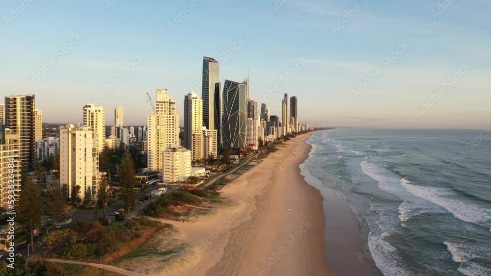 Aerial fly over beach with skyline view of Surfers Paradise cityscape at sunrise. Gold Coast, Australia Aerial fly over beach with skyline view of Surfers Paradise cityscape at sunrise. Gold Coast, Australia