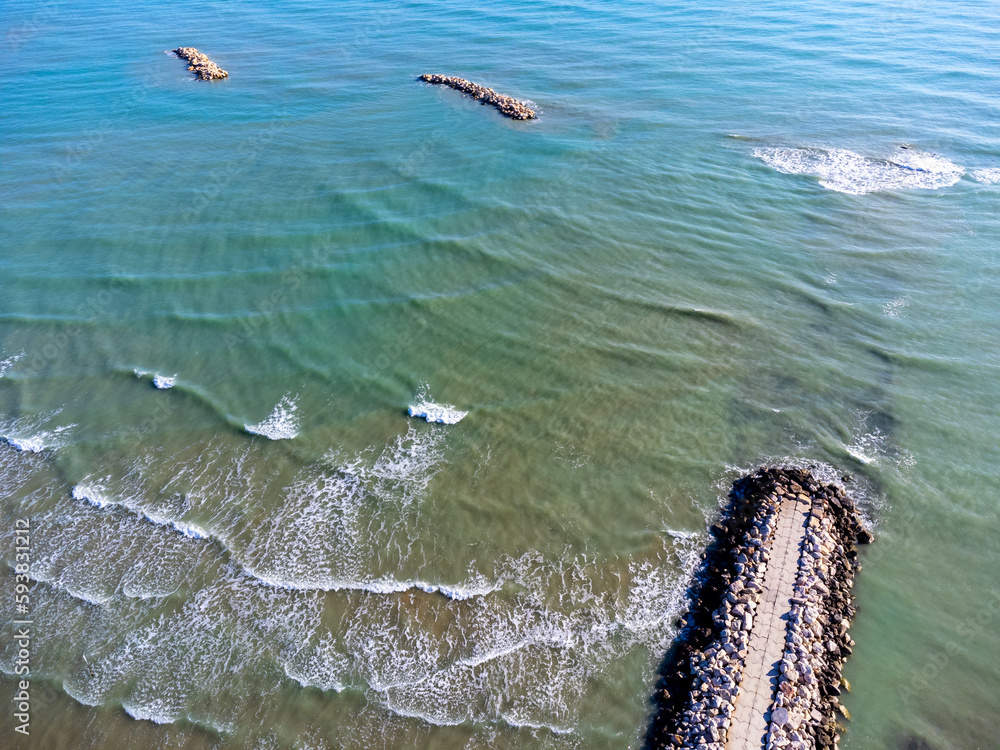 Aerial view landscape Italy Pescara. Sea, waves, breakwater, stones, rocks, beach, sand, empty.