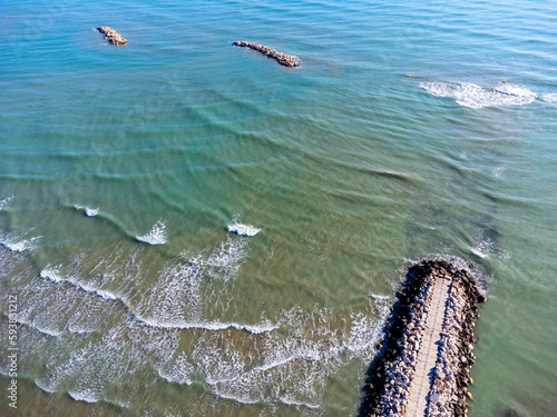 Obraz na płótnie Aerial view landscape Italy Pescara. Sea, waves, breakwater, stones, rocks, beach, sand, empty. w salonie