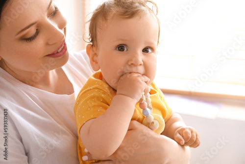 Young mother holding her li...