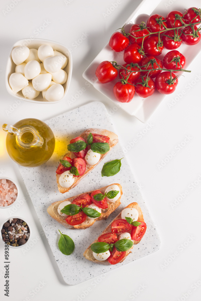 Tomato, basil and mozzarella cheese fresh made caprese bruschetta. Italian tapas, antipasti with vegetables, herbs and oil on grilled ciabatta and baguette bread. Open sandwich. Tomato, basil and mozzarella cheese fresh made caprese bruschetta. Italian tapas, antipasti with vegetables, herbs and oil on grilled ciabatta and baguette bread. Open sandwich.