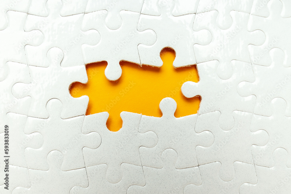 Fototapeta premium White puzzles without two puzzles on orange background