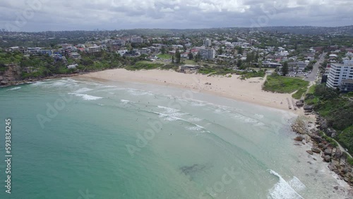 People At The Freshwater Beach Near Manly, Beachside Suburb Of Sydney In New South Wales, Australia. aerial sideways photo
