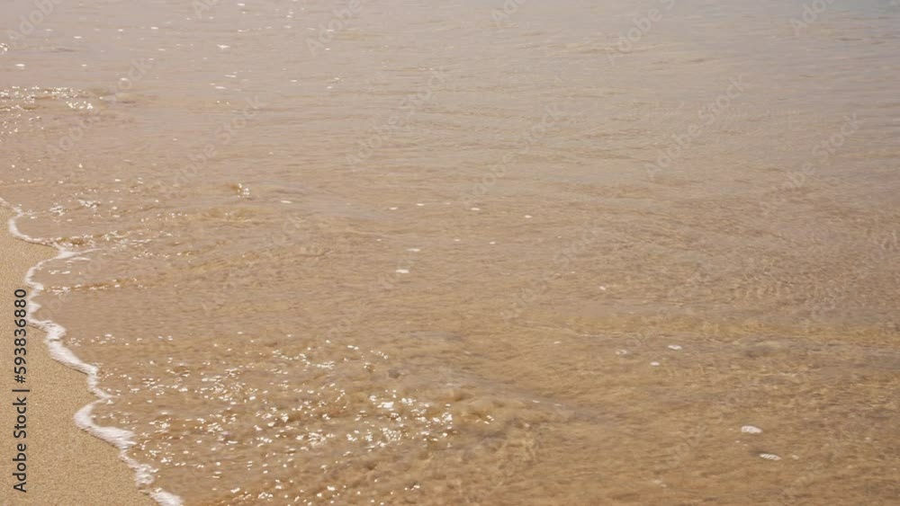 Human Footprints In the Seashore Sand Disappear Under the Waves Crashing on the Shore. Sea Waves Washing Off Footprints on the Sand of the Beach. The Concept of the Frailty of Human Existence Human Footprints In the Seashore Sand Disappear Under the Waves Crashing on the Shore. Sea Waves Washing Off Footprints on the Sand of the Beach. The Concept of the Frailty of Human Existence