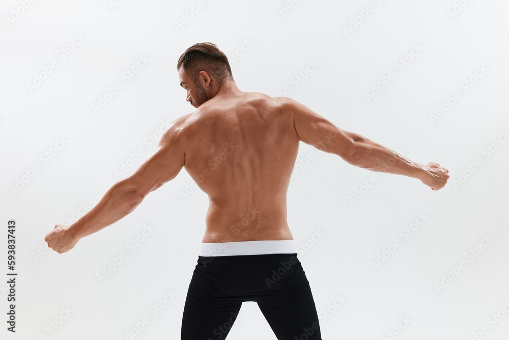 Man athletic body bodybuilder in briefs with naked torso abs full-length in the background, fitness classes. Advertising, sports, active lifestyle, competition, challenge concept. Man athletic body bodybuilder in briefs with naked torso abs full-length in the background, fitness classes. Advertising, sports, active lifestyle, competition, challenge concept.