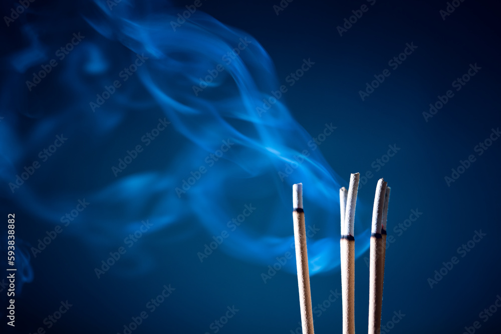Incense sticks and incense stick smoke on black backgrond with white backlit Incense sticks and incense stick smoke on black backgrond with white backlit