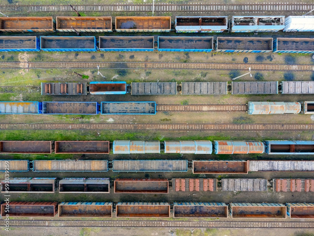 Aerial view of freight trains. Aerial view from flying drone of colorful freight trains at railroad station. Carriages of goods on a railroad. Heavy industry. Industrial conceptual scene with trains.