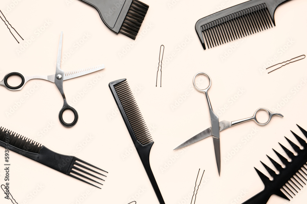 Fototapeta premium Hairpins with brushes and scissors on beige background