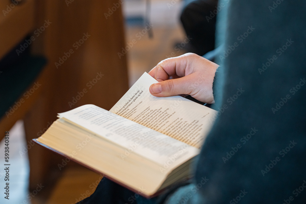 Naklejka premium Person holding hymnbook at Næsby Church in Odense Denmark from the inside