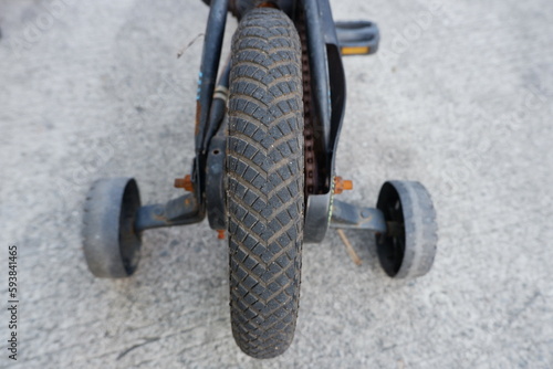 four wheel bicycle. assist wheels to help a child learn to ride a bicycle. selective focus and soft focus