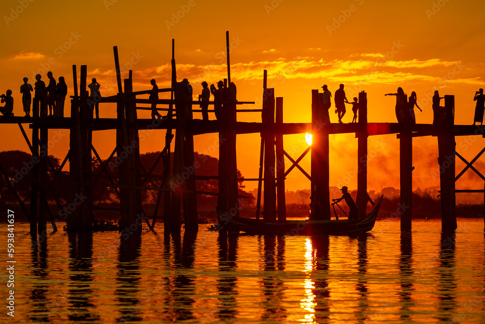 Mandalay,Myanmar, November 16, 2016: Unidentified people crossing famous U Bein bridge. The place is one of most visited sights in Burma