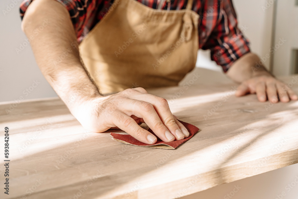 Obraz premium Carpenter works with wood in the workshop. Small business, production, craft concept.