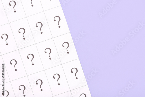 Paper with question marks o...