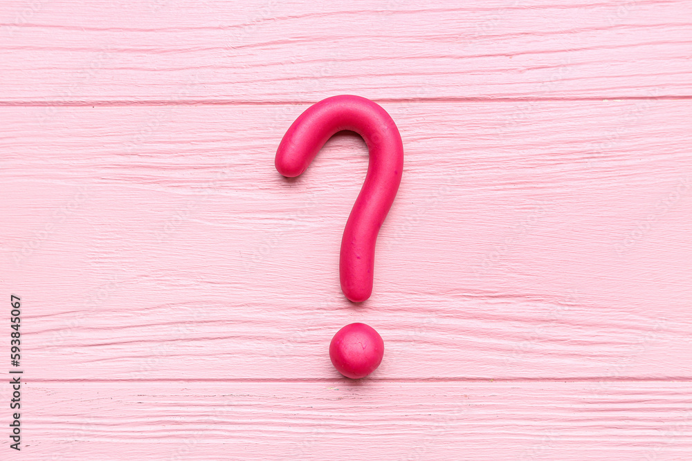 Question mark made of plasticine on pink wooden background Question mark made of plasticine on pink wooden background