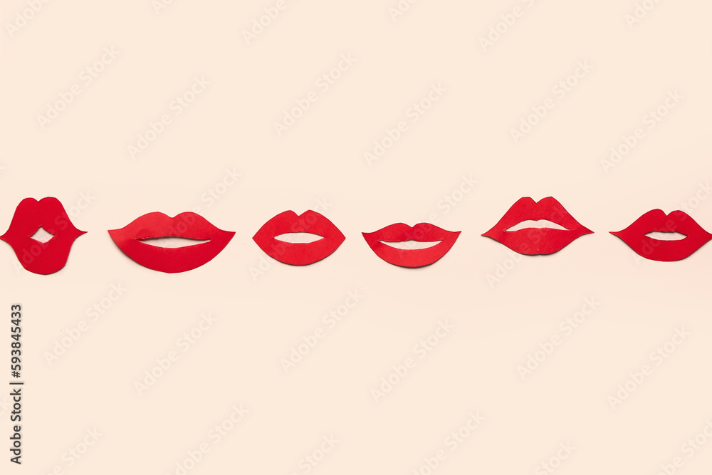 Red paper lips on beige background Red paper lips on beige background