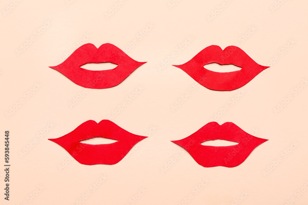 Fototapeta premium Red paper lips on beige background