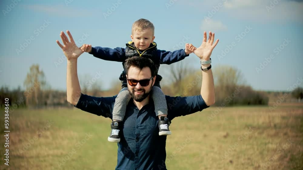father with boy child walking together and having a fun time father with boy child walking together and having a fun time