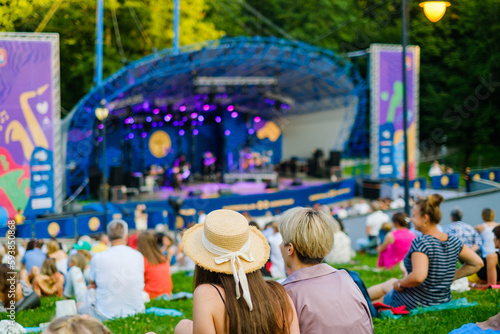 Fototapeta Naklejka Na Ścianę i Meble -  People gathering in park during concert
