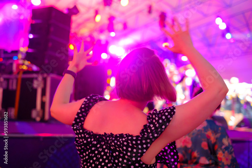 Woman dancing near stage during concert