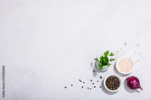 Kitchen cooking background with black peppercorn, purple onion, fresh parsley and sea salt