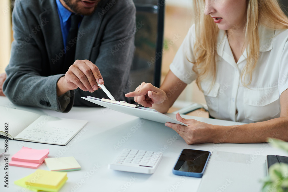 Cropped image of business people proofreading contract before meeting with investor Cropped image of business people proofreading contract before meeting with investor