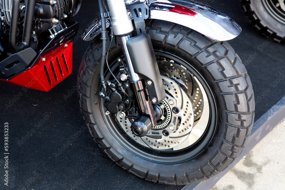Obraz premium Motorcycle wheels with car accessories in showroom