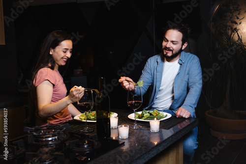 Young latin couple dining on celebration toasting at home in Mexico Latin America  hispanic people