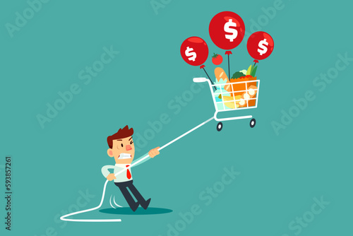 businessman holding rope tie to floating shopping cart with balloon