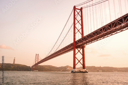 the Cristo Rei Statue and the Ponte 25 de Abril or 25the April Bridge at the Rio Tejo near the City of Lisbon in Portugal. Portugal, Lisbon