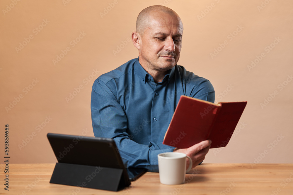 Mature businessman reading a book at work Mature businessman reading a book at work
