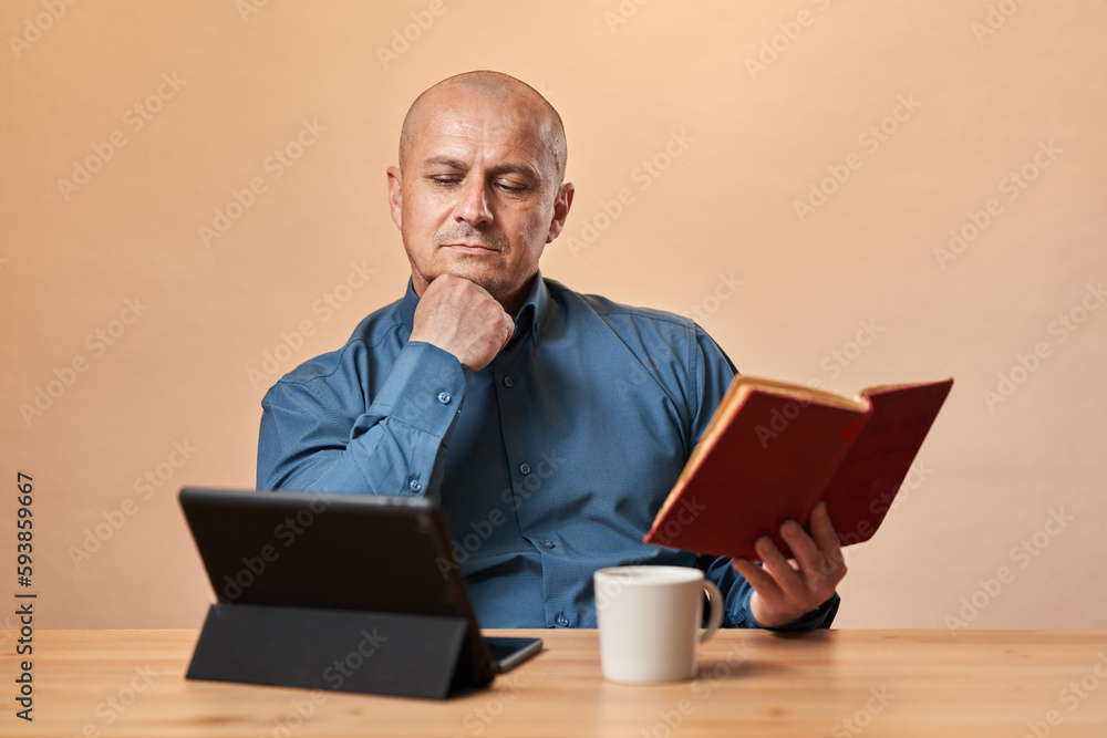 Mature businessman reading a book at work Mature businessman reading a book at work